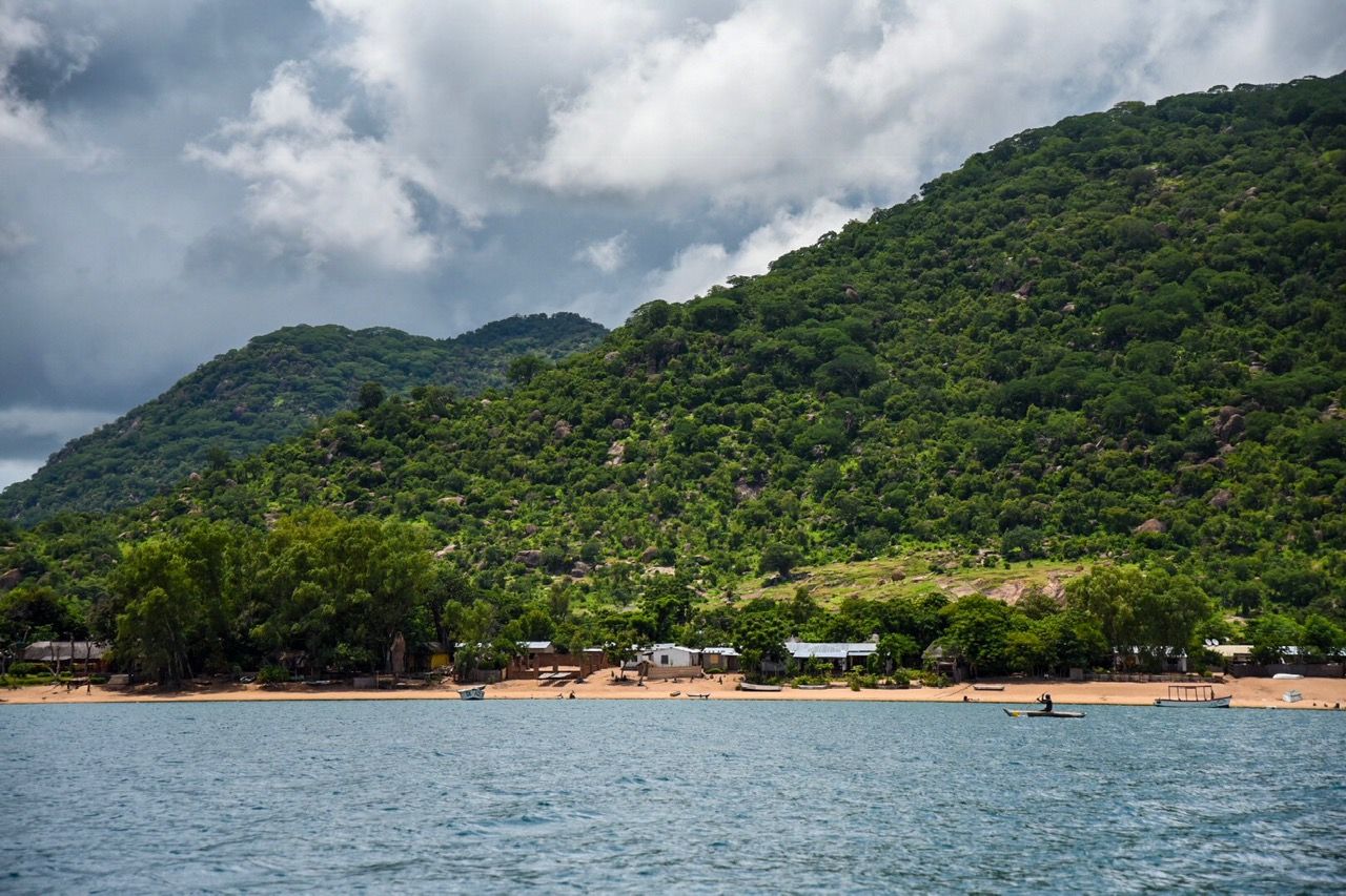Green hills rising above a lakeshore village